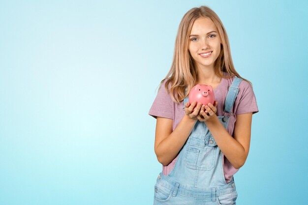 Picture of lovely woman with piggy bank