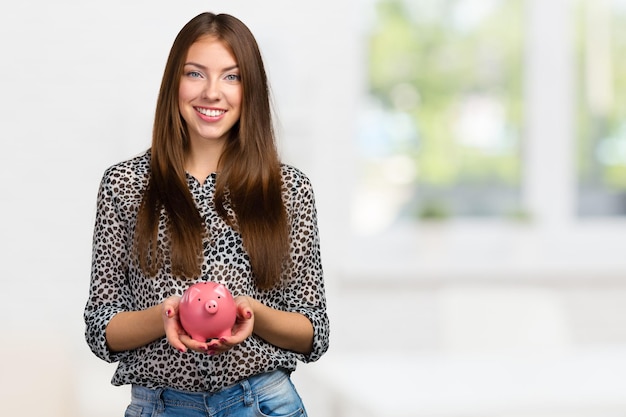 Free photo picture of lovely woman with piggy bank