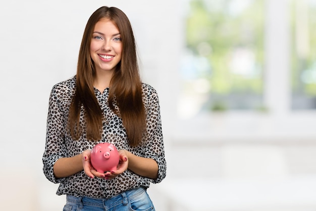Picture of lovely woman with piggy bank