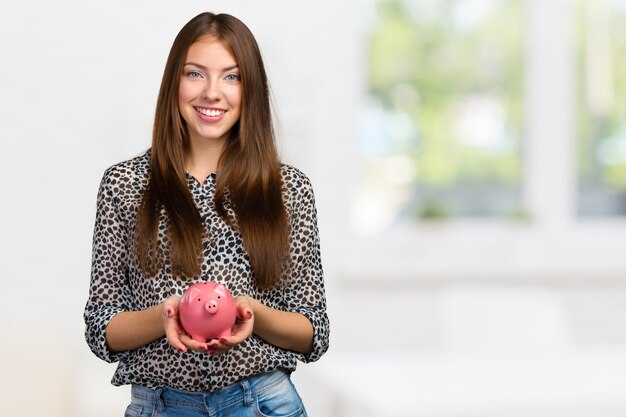 Picture of lovely woman with piggy bank