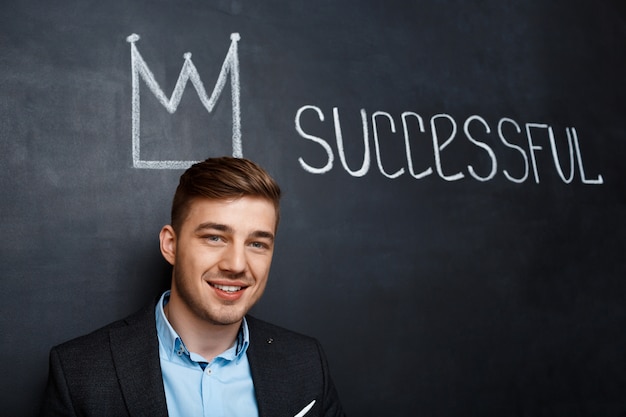 picture of man over blackboard with crown and text successful