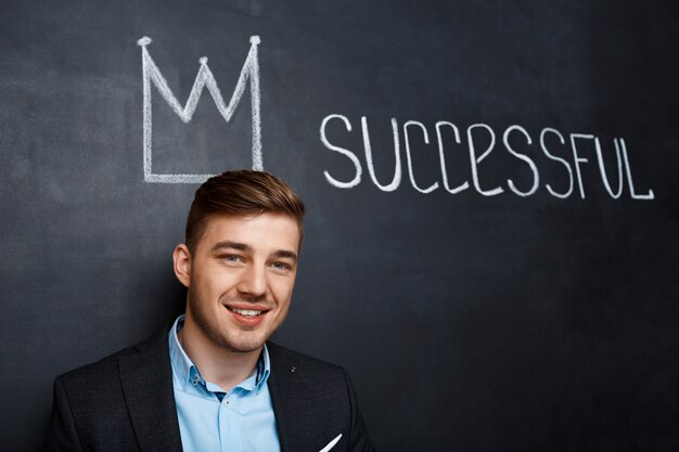 picture of man over blackboard with crown and text successful