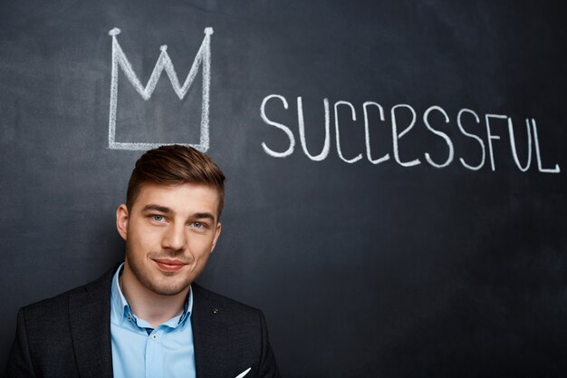 picture of man over blackboard with crown and text successful