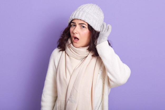 Picture of shocked emotional cute woman standing with widely opened mouth