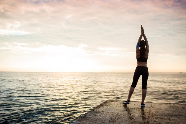 Picture of young beautiful fitness woman makes sport exercises