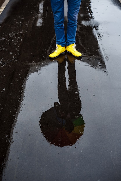 Picture of young businessman 39 s yellow shoes in rainy street