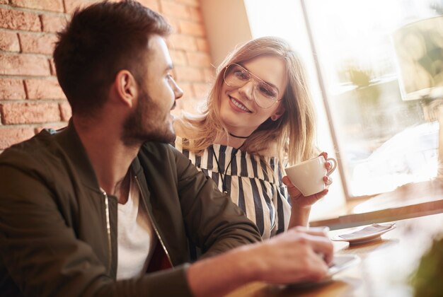 Picture of young couple having cup of coffee
