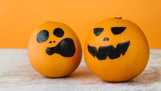 Pictured oranges with scream and smirk faces