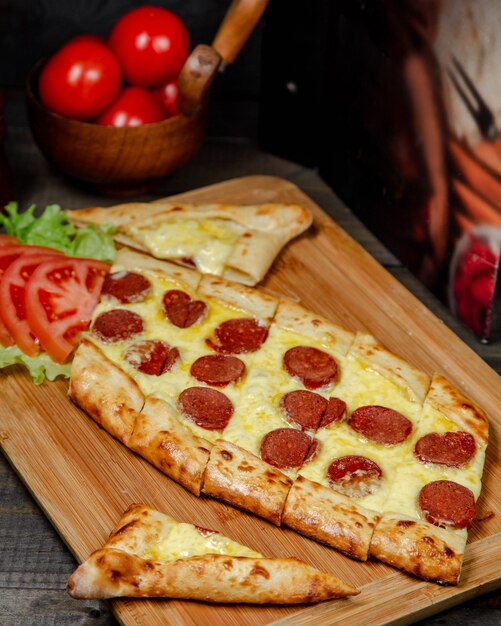Pide with cheese and sausages