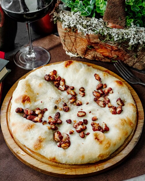 Pie with nuts on a wooden plate