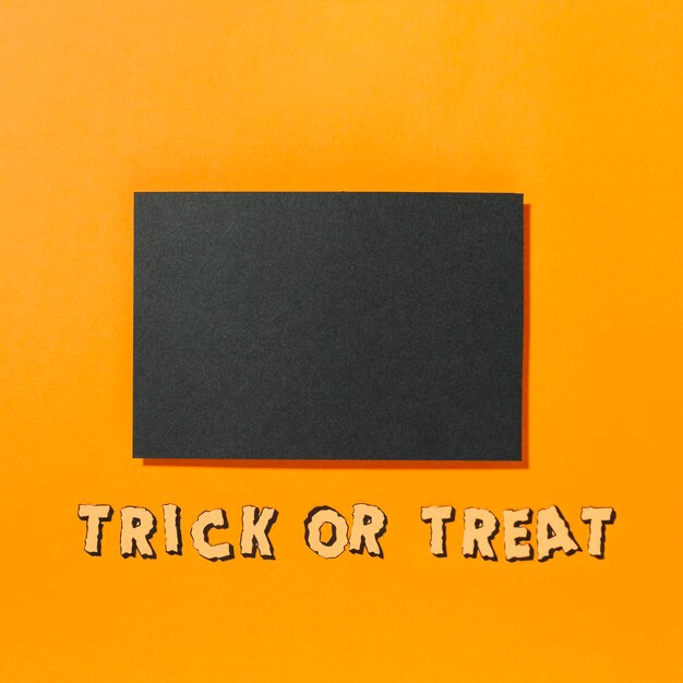 Piece of black paper with Trick or Treat inscription below