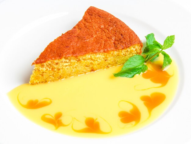 Piece of cake with yellow sauce