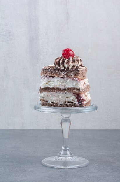 A piece of delicious cake on glass plate.