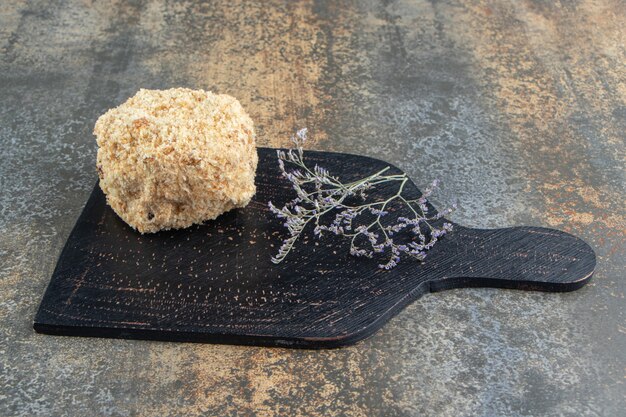 Piece of homemade cake on black board