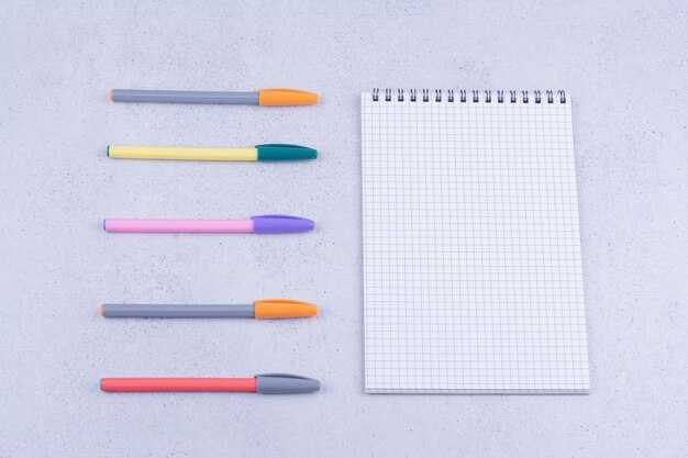 A piece of paper with multicolor pencils around