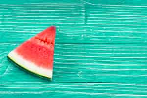 Free photo piece of  red juicy watermelon on green background