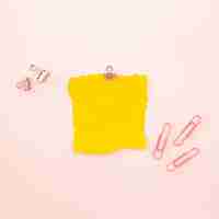 Free photo piece of yellow sheet on a pink background