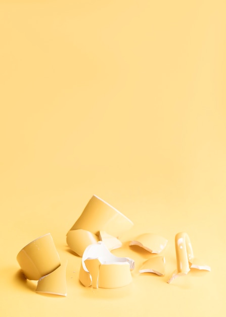 Pieces of a broken yellow mug