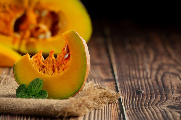 Pieces of cut raw pumpkin  are placed on the burlap