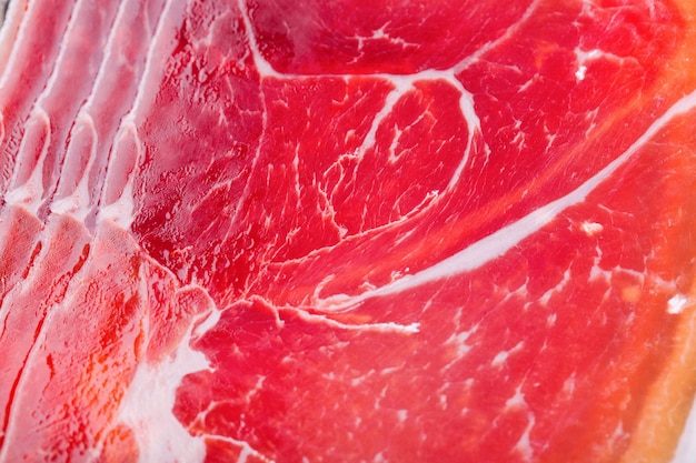 Pieces of cut red meat lie on each other