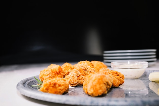 Pieces of fried chicken lying on tray 