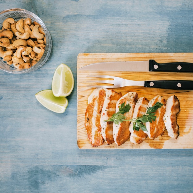 Pieces of roasted chicken on cutting board