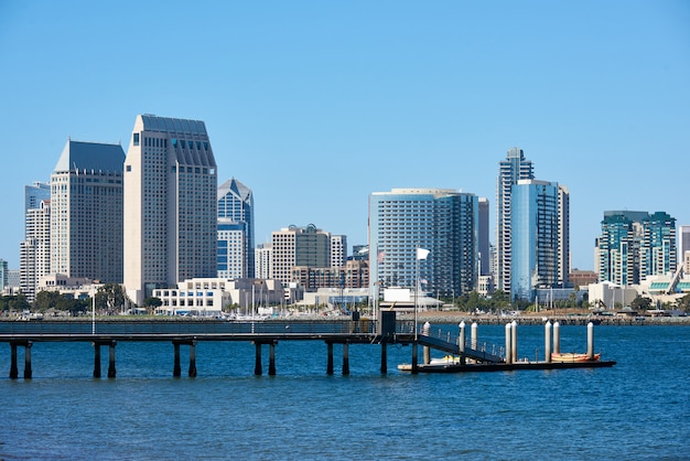 Pier with kayak boats, downtown skyline  in San Diego