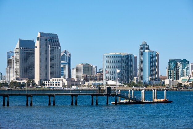 Pier with kayak boats, downtown skyline  in San Diego