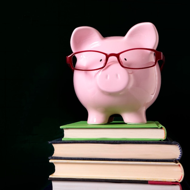 Piggy bank glasses books blackboard