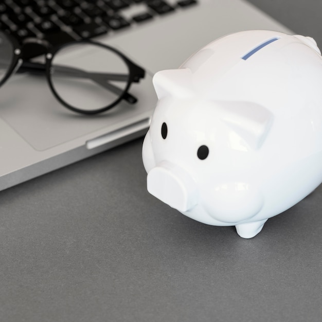 Piggy bank next to laptop