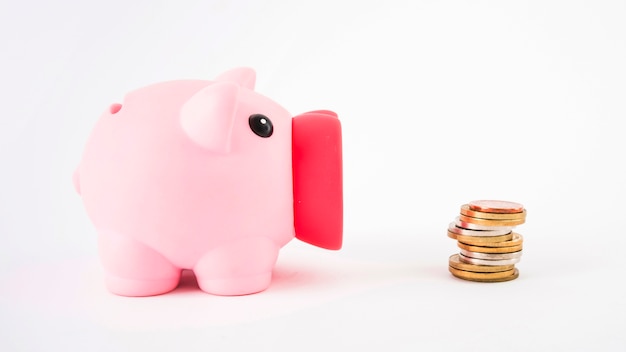 Piggy bank with coins on table