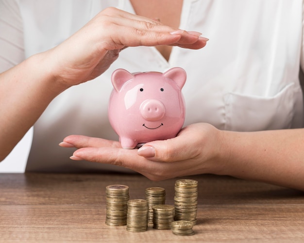 Free photo piggy bank with piles of coins