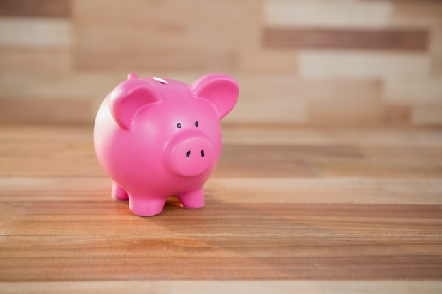 Piggy bank on wooden surface