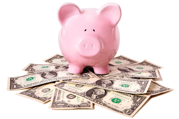 Piggybank above dollar notes