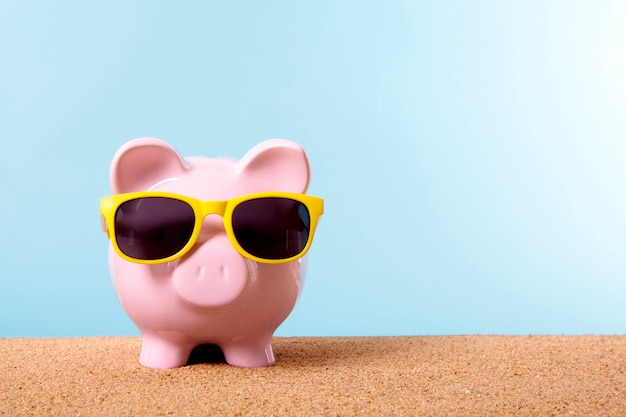 Free photo piggybank with yellow sunglasses