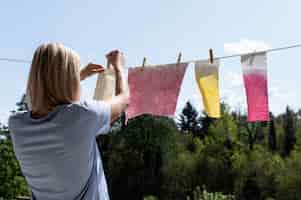 Free photo pigmented cloths held by pegs composition