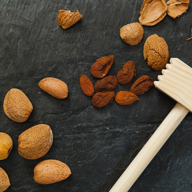 Pile of almonds and steak hammer