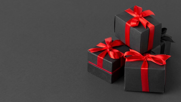 Pile of black wrapped gifts copy space