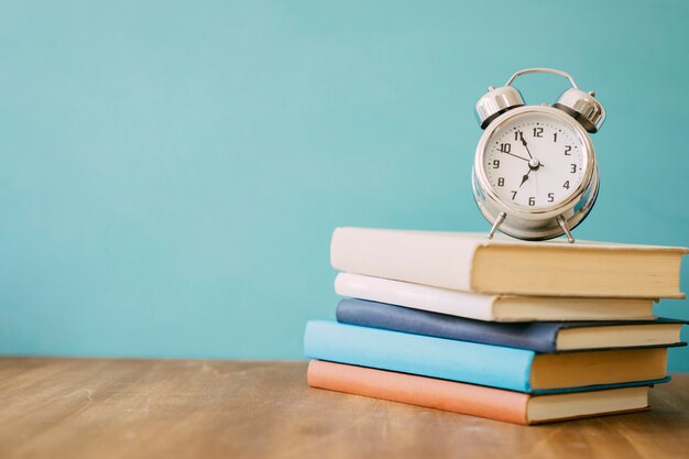 Pile of books and clock