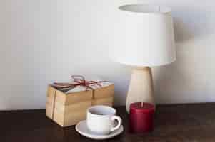 Free photo pile of books lamp and candle