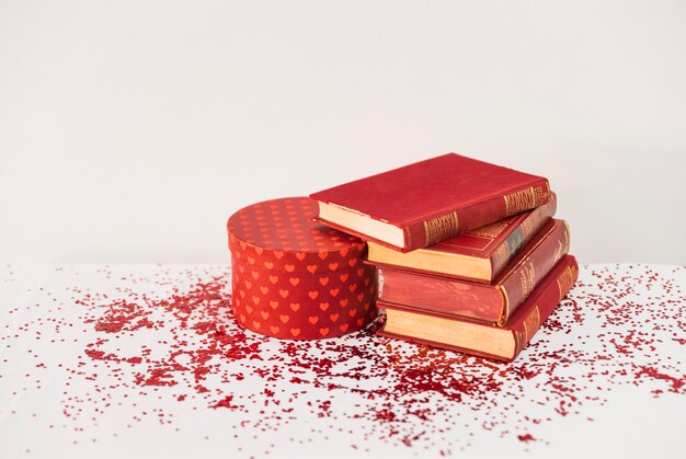 Pile of books near present on table