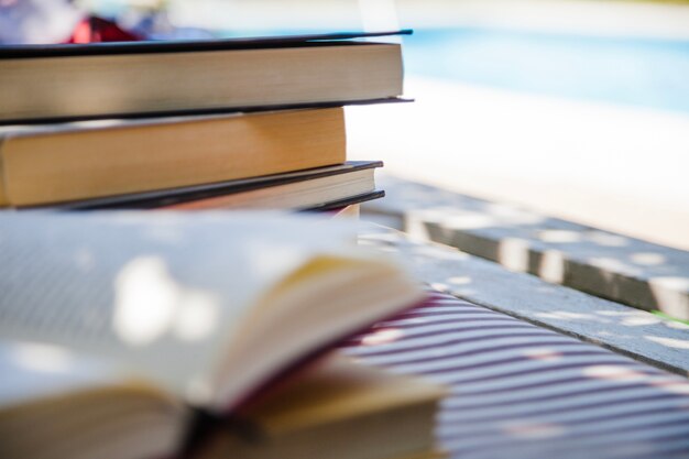 Pile of books placed on feather bed