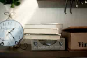 Free photo pile of books on shelf near decorations