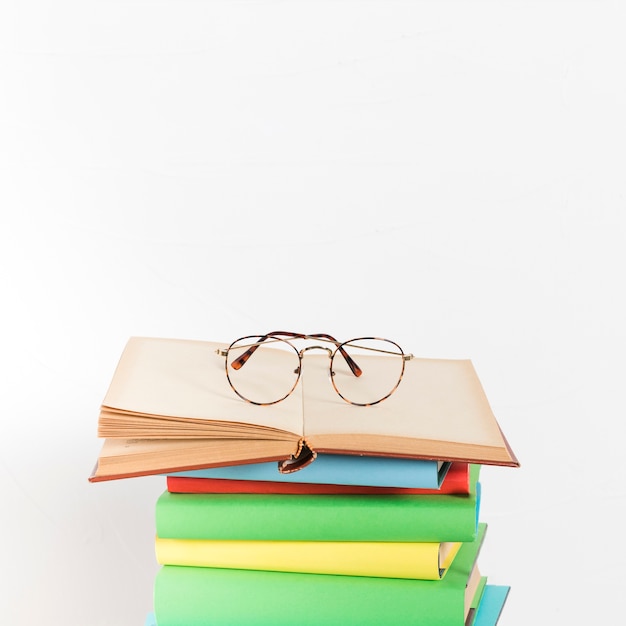 Pile of books with glasses