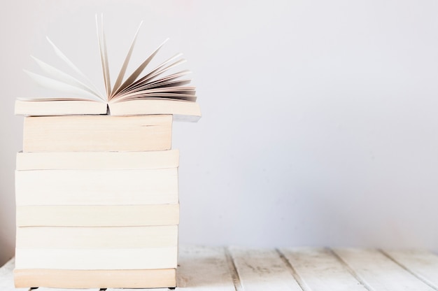 Free photo pile of books on wooden table