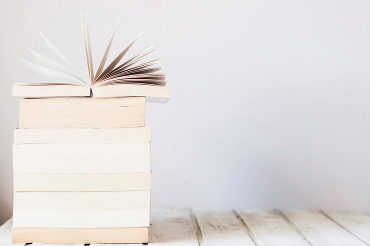 Free Photo pile of books on wooden table