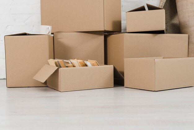 Pile of cardboard boxes on white floor