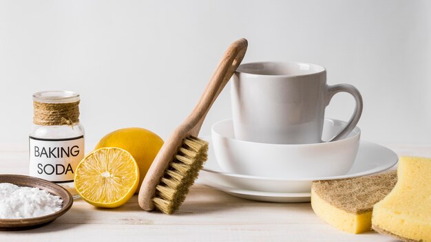 Pile of clean dishes and eco cleaning products