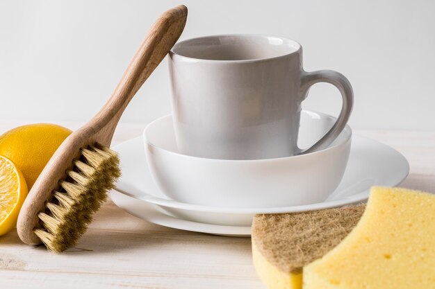 Pile of clean dishes and natural cleaning products