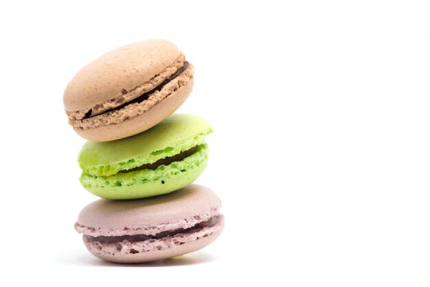 Pile of colorful macarons isolated white background